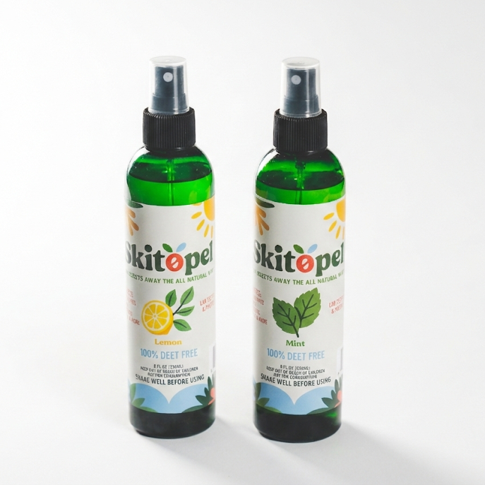 Two bottles of skitopel spray on a white background